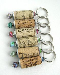 four wine corks with charms attached to them