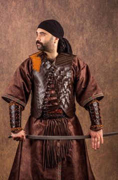 Embody the spirit of Osman Ghazi with this handcrafted leather costume armor set! This professional-grade armor, meticulously crafted from high-quality cowhide, is perfect for historical reenactments, LARP events, cosplay, or simply showcasing your Turkish warrior spirit. Features:     Handcrafted Quality: Every detail is hand-stitched, replicating traditional production methods for an authentic look and feel.     Durable Leather: Made from genuine cow leather, this armor is built to withstand t Warrior Costumes For Medieval Fantasy Events, Warrior Costumes For Medieval Festivals, Viking Costumes For Larp And Medieval Festivals, Viking Costume For Medieval Festivals, Traditional Fitted Costume For Larp, Fitted Traditional Costumes For Larp, Turkish Warrior, Leather Costume, Costume Armour