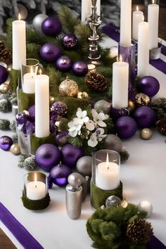 a table topped with lots of candles next to purple and silver decorations on top of it