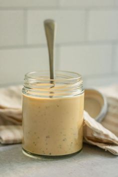 balsamic tahini dressing in a jar with a spoon