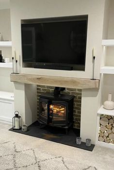 a living room with a fireplace and tv above it