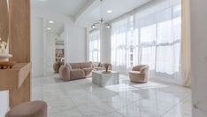 a living room filled with furniture and white walls