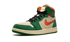 The Air Jordan 1 High Zoom CMFT 2 "Pine Green" is a colorway of the modified version of the retro basketball shoe with green and orange details.  The Jordan 1 Zoom Comfort 2 is the second version of the Jordan 1 Zoom Comfort shoe that puts a casual, more comofrtable spin on the classic silhouette.  The “Pine Green” features a Muslin suede base with Pine Green suede overlays.  An Orange Blaze cut-out Swoosh appears on the sides and a “Wings” logo is found on the collar.  “Zoom Air” branding repla Green Throwback Sneakers For Streetwear, Casual Green Basketball Shoes For Streetwear, Green Basketball Shoes With Boost Midsole For Streetwear, Casual Green Basketball Shoes With Gum Sole, Green Low-top Basketball Shoes With Gum Sole, Green High-top Basketball Shoes For Streetwear, Low-top Green Basketball Shoes With Gum Sole, Green High-top Sneakers With Gum Sole For Streetwear, Green Jordan Shoes With Rubber Sole For Sports