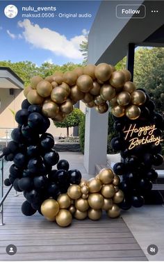 black and gold balloons with happy birthday written on them