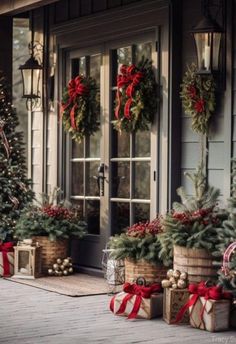 christmas decorations on the front porch of a house with holiday wreaths and presents in baskets