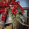 a bell decorated with holly and red ribbon