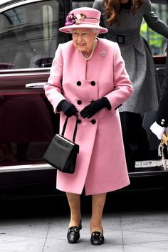 an older woman in a pink coat and hat