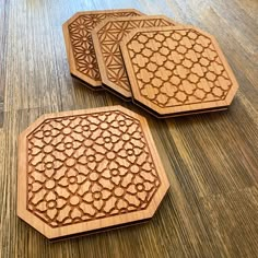 three wooden coasters sitting on top of a table