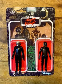 two star wars action figures are shown on a wooden surface, one is black and the other is red