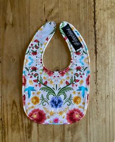 Mexican flowers print baby bib. Each bib is made of cotton print fabric on top and super soft minky on the bottom. It also has a 3rd layer of fabric in the middle for extra protection. Bib measures about 7 1/2x12 inches and has a velcro closure. It's the perfect size for a 0-6 month old. It can be used longer depending on the size of your baby. The picture used is a sample picture. Pattern placement may vary but I will get it as close as I can to the picture. Minky back color may very. If you want a certain color let me know in the notes section and I will do my best to meet your request. If it's blank, a random color of my choice will be shipped. Be sure to take a look at all of my items https://www.etsy.com/shop/My2Moochies?ref=seller-platform-mcnav Cute Multicolor Machine Washable Bib, Mexican Flowers, Baby Prints, Baby Bibs, Bibs, Flower Print, Flower Prints, Printing On Fabric, Let Me