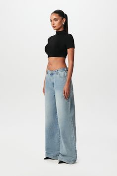 Our oversized denim wide-leg pant brings retro to the modern style. Designed with waist-button tab-adjustability for your waist preference. Front zipper with button closures and multi-pockets to complete the relaxed fit. Style with sneakers or heels to create versatile looks. Denim Collection Import 100% Cotton Oversized fit True to size Inseam: Size 27 - 33" Inseam: Size 31 - 35" Kardashian Denim Photoshoot, Oversized Jeans And Heels, Levi Wide Leg Jeans, Palazzo Jeans Outfit, Levis Wide Leg Jeans, Mh Aesthetic, Style With Sneakers, Jeans Oversize, Denim Photoshoot