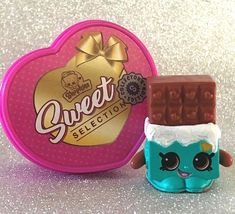 a small toy next to a candy box