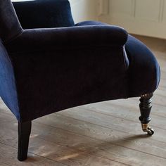 a blue chair sitting on top of a hard wood floor