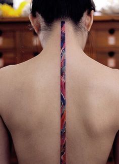 the back of a woman's neck with a tie on it