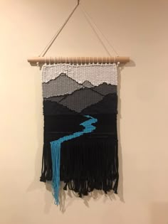 a wall hanging with a river running through it