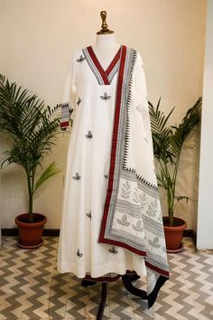 Ivory cotton silk kurta with leaf motif hand block print and hand embroidery. Comes with pant and a dupatta.
Components: 3
Pattern: Hand block printed, Hand embroidered
Type Of Work: Leaf motifs
Neckline: V Neck
Sleeve Type: Three quarter
Fabric: Cotton silk
Color: Ivory
Other Details: 
Length :
Kurta : 50 inches
Pant : 36 inches
Occasion: Work - Aza Fashions White Cotton Kurta With Printed Border, White Straight Kurta Sets With Printed Border, Elegant Block Print Cotton Sets, Elegant White Kurta With Traditional Patterns, Elegant Cotton Block Print Sets, White Sets With Printed Border And Straight Kurta, Elegant Cotton Sets With Block Print, Festive White Block Print Sets, Traditional White Block Print Kurta