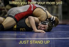 a wrestler wrestling with the words just stand up