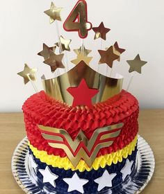 a cake decorated with stars and the number four on top is sitting on a plate