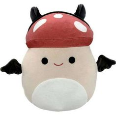 a close up of a stuffed animal with a mushroom on it's head and eyes