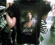 a person holding up a t - shirt with an image of a woman on it