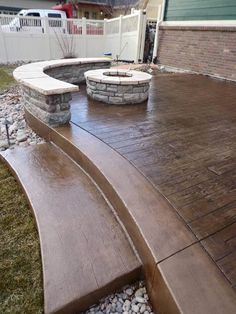 a wooden bench sitting in the middle of a yard