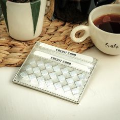 Handmade. Color: Silver Height: 8 cm | 3.1'' Width: 10,5 cm | 4.1" Depth: 0,5 cm | 0.2'' Weight: 0.06 kg - 0.07 kg Premium quality is our first priority. Every process of our hand-woven card holders is made by master by hand.  One side weaved intrecciato leather with 3 slots, other side plain with 3 slots and a central pocket for notes, receipts or additional cards. Each card slot is equipped with lining, keeping your personal and financial info safe. High Quality Durable Leather Sleek and Long-Lasting Look Rigorous Quality Control Unique, slim, minimalist, compact, stylish and luxury handmade card holder. Unisex style. Great gift for a girlfriend or boyfriend, husband or wife, moder or father, daughter or son, brother or sister, groomsmen or best friend in your life. This gorgeous card ho Luxury Compact Card Holder As Gift, Luxury Compact Card Holder For Gift, Luxury Silver Wallet As Gift, Wallet Luxury, Leather Card Holder Wallet, Wallet Minimalist, Leather Card Holder, Clip Wallet, Make Happy