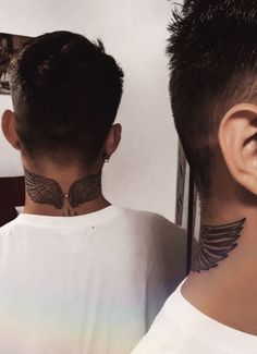 two men with tattoos on their neck and behind the ear