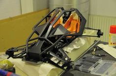 a laptop computer sitting on top of a desk covered in clutter and paper towels