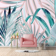 a pink chair sitting in front of a wall mural with palm leaves on it's side