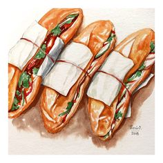 three sub sandwiches wrapped in paper on top of each other