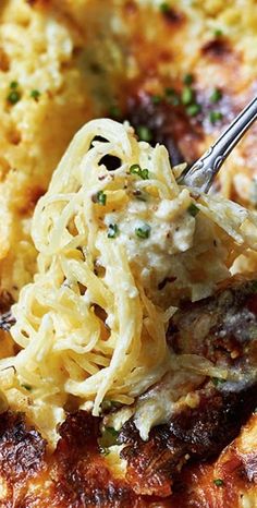 a close up of food on a plate with a fork in it and broccoli sprouts