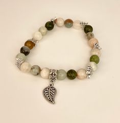 Natural Stone Beads in Green White and Beiges with silver toned Butterfly spacers and Leaf Charm - 7 inch Elastic Bracelet This is a Beautiful Elastic style Bracelet. beads are about 8mm. You will receive a nylon gift bag for your gift giving. You will choose gift bag color at checkout. If you have any questions send me a message. Bohemian Silver Charm Bracelet With 8mm Beads, Silver Bohemian Charm Bracelet With 8mm Beads, Silver Bohemian Stretch Bracelet With 8mm Beads, Natural Stone Beads, Elastic Bracelet, Leaf Charms, Stone Beads, Minneapolis, Fashion Bracelets