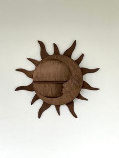 a wooden sun and moon hanging on the wall