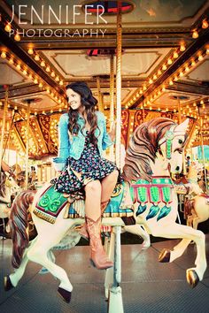 a woman sitting on top of a merry go round