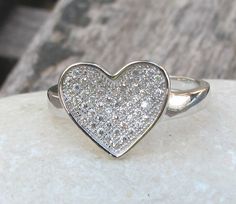 A lovely heart ring adorned with pave set crystals, makes a sweet gift. Wrapped in a box ready for gift giving.(r48) Heart measure 10mm x 13mm. *LIKE* us on Facebook http://www.facebook.com/Belesas to get 10%off coupon code, *FOLLOW* us on Twitter https://twitter.com/#!/Belesas to get more exclusive coupon codes *All item are ready to ship! Free shipping on orders over $150 using coupon code BELESAS150 ---------------------------------------------------- ENTER MY SHOP ► http://www.etsy.com/shop/ Cubic Zirconia Heart Ring For Mother's Day Gift, Mother's Day Gift Heart Ring With Cubic Zirconia, Mother's Day Gift Cubic Zirconia Heart Ring, Diamond Heart Ring As A Gift, Heart-shaped White Diamond Ring For Gift, Valentine's Day Gift Diamond Ring With Double Heart Shape, Silver Heart Cut Ring For Anniversary Gift, Silver Heart Cut Ring For Anniversary, Heart-shaped White Diamond Ring Gift