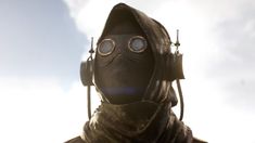 a man wearing a gas mask and headphones in front of a cloudy blue sky