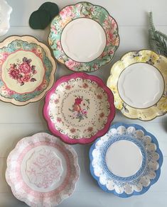 five plates with different designs on them sitting next to each other and one is empty