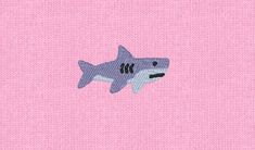 a pink background with a shark embroidered on the back of it's face and chest