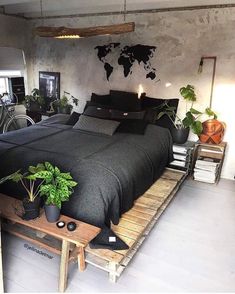 a bed room with a neatly made bed and lots of plants on the side table