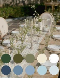 the table is set with white and blue plates, vases, and flower centerpieces