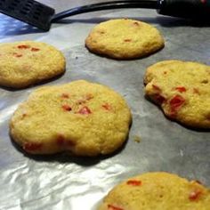 six cookies are on a baking sheet ready to go into the oven