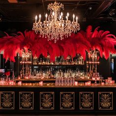 a fancy bar with red feathers and candles