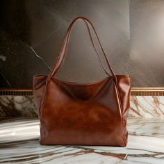 This premium brown leather tote bag is a timeless blend of elegance and functionality. Handcrafted from genuine leather, it's perfect for daily use, offering both durability and sophisticated style. Ideal for the modern woman who values quality and understated luxury. Brown Leather Tote Bag, Brown Leather Totes, Understated Luxury, Sophisticated Style, Leather Tote Bag, Minimalist Fashion, Modern Woman, Leather Tote, Leather Shoulder Bag