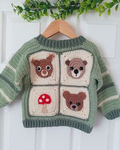 a crocheted sweater with bears and mushrooms on it