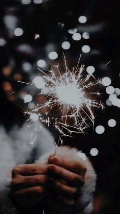 a person holding a sparkler in their hand