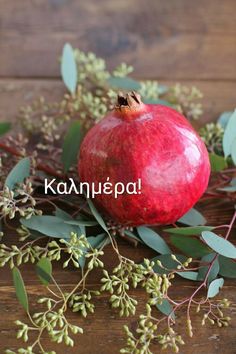 a pomegranate sitting on top of green leaves and branches with the words kannupa written in russian