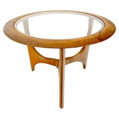 an oval glass table with wooden legs on a white background in the shape of a bird's eye view