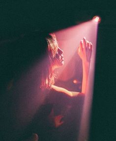 a woman standing in front of a bright light