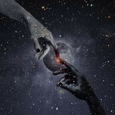 two hands reaching out towards each other in front of a star filled sky with stars