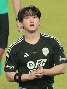 a young man standing on top of a soccer field